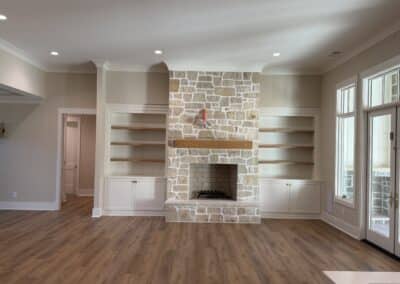 Stone fireplace with built-in shelving in great room Canton GA custom home