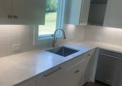 walk in pantry with tile backsplash sink and lighting Gainesville GA