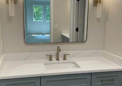 bathroom with blue gray cabinets custom lighting Gainesville GA