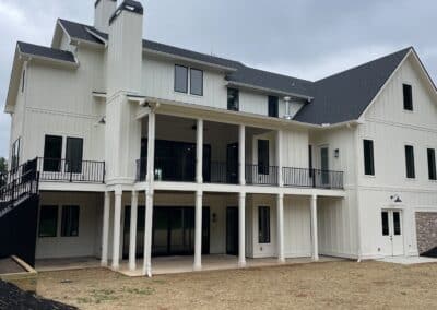 Rear exterior two-level covered porch Canton GA custom home